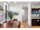 The dining room shows a wooden table, large windows, and a view of the kitchen with stainless steel appliances at 2518 N Washington St, Denver, CO 80205