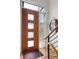 Contemporary entryway featuring a wood front door with glass inserts and stylish staircase at 2518 N Washington St, Denver, CO 80205