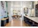 Modern kitchen and dining room with stainless steel appliances, dark wood cabinets and a hardwood floor at 2518 N Washington St, Denver, CO 80205