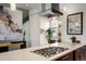 Modern kitchen features stainless steel appliances, an island cooktop, pendant lighting, and dark wood cabinets at 2518 N Washington St, Denver, CO 80205