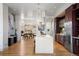 Open-concept kitchen featuring a large island, stainless steel appliances, and seamless access to the dining area at 2518 N Washington St, Denver, CO 80205