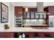 Modern kitchen featuring stainless steel appliances, sleek countertops, and rich wood cabinetry at 2518 N Washington St, Denver, CO 80205