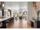 An open-concept living room with a modern kitchen, hardwood floors, and large windows with natural light at 2518 N Washington St, Denver, CO 80205