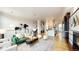 Bright open-concept living room featuring modern decor, a fireplace, and seamless flow to the kitchen at 2518 N Washington St, Denver, CO 80205
