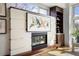 Bright living room boasts a modern fireplace, and stylish furnishings, creating an inviting space at 2518 N Washington St, Denver, CO 80205