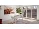 Bright home office with a modern white desk, stylish rug, and natural light from a sliding glass door at 2518 N Washington St, Denver, CO 80205