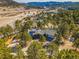 The house has solar panels and is nestled in the trees on a sunny day at 312 Meadow View Dr, Evergreen, CO 80439