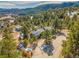 Gorgeous aerial view of a home with solar panels surrounded by lush trees at 312 Meadow View Dr, Evergreen, CO 80439