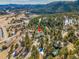 Beautiful aerial view showcases property nestled in a dense, mature forest at 312 Meadow View Dr, Evergreen, CO 80439