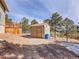 Backyard features a shed with a wood deck on a sunny day at 312 Meadow View Dr, Evergreen, CO 80439