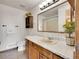 Cozy bathroom featuring a speckled countertop, wood cabinets, and decorative wall cabinet with an indoor plant at 312 Meadow View Dr, Evergreen, CO 80439