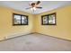 Sunny bedroom with soft carpet, framed windows, and vibrant yellow walls that bring in cheerful light at 312 Meadow View Dr, Evergreen, CO 80439