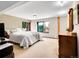 Bright basement bedroom featuring big windows, soft carpet, and wooden furniture at 312 Meadow View Dr, Evergreen, CO 80439