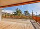 A spacious deck with wood railings, ideal for enjoying the surrounding nature and mountain views at 312 Meadow View Dr, Evergreen, CO 80439