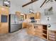 Bright kitchen features stainless steel appliances, light wood cabinetry, and granite countertops at 312 Meadow View Dr, Evergreen, CO 80439