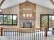 Upstairs landing view of spacious living room featuring vaulted ceilings, stone fireplace, and wood accents at 312 Meadow View Dr, Evergreen, CO 80439