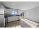 Bright kitchen with white cabinets, stainless steel appliances, and tile flooring with a patio view at 3272 W 10Th Avenue Pl, Broomfield, CO 80020