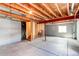 Unfinished basement with exposed wood beams and stairs, ready for customization at 5549 Helena St, Denver, CO 80239
