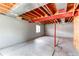 Unfinished basement with exposed beams, concrete floor and window, perfect for storage or customization at 5549 Helena St, Denver, CO 80239