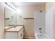 Bright bathroom features a shower and tub combination, vanity, lighting, and natural color paint at 5549 Helena St, Denver, CO 80239
