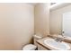 Bathroom featuring a single sink vanity, toilet, and neutral-toned walls at 5549 Helena St, Denver, CO 80239