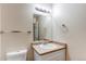 Bathroom featuring a single sink vanity, toilet, and wall-mounted towel rack at 5549 Helena St, Denver, CO 80239