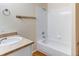 Bright bathroom featuring a shower and tub combination and a vanity with solid surface counter at 5549 Helena St, Denver, CO 80239