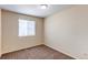 Bedroom featuring a window, neutral paint, and carpet at 5549 Helena St, Denver, CO 80239
