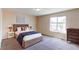 Comfortable bedroom with a large window, plush carpet, and stylish decor at 5549 Helena St, Denver, CO 80239