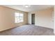 Neutral bedroom features neutral carpet, a large window, and a closet at 5549 Helena St, Denver, CO 80239