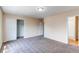 Spacious bedroom featuring neutral paint and carpet, a closet, and an en suite bathroom at 5549 Helena St, Denver, CO 80239