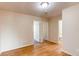 Neutral bedroom with two doorways and wood floors at 5549 Helena St, Denver, CO 80239