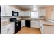 Well-lit kitchen showcasing white cabinets, modern appliances and a stylish backsplash at 5549 Helena St, Denver, CO 80239