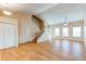 Spacious living room with a vaulted ceiling, wood-look floors and a staircase leading to the second floor at 5549 Helena St, Denver, CO 80239