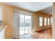 Open-concept living space with sliding glass door to backyard at 5549 Helena St, Denver, CO 80239