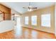 Bright living room featuring wood-look floors, a ceiling fan, and multiple windows for plenty of natural light at 5549 Helena St, Denver, CO 80239
