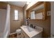 Well-lit bathroom featuring a modern vanity and shower/tub combination at 2080 Fulton St, Aurora, CO 80010