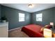 Cozy bedroom featuring two windows, a neutral color scheme, and carpeted floors at 2080 Fulton St, Aurora, CO 80010