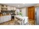 Charming kitchen boasts stainless steel appliances, butcher block countertops, and a center island with seating at 2080 Fulton St, Aurora, CO 80010