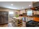 Charming kitchen boasts stainless steel appliances, butcher block countertops, and a center island with seating at 2080 Fulton St, Aurora, CO 80010