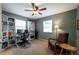 Well-lit home office with built-in shelving and comfortable seating area at 2080 Fulton St, Aurora, CO 80010