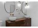 Contemporary bathroom featuring a double vanity with vessel sinks, stylish mirrors, and elegant lighting at 690 S Newark Ct, Aurora, CO 80012
