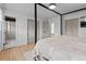 Primary bedroom featuring a four-poster bed frame, ensuite bathroom, and closet at 690 S Newark Ct, Aurora, CO 80012