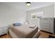 Cozy bedroom features a neutral color palette, hardwood floors and natural light from the window at 690 S Newark Ct, Aurora, CO 80012