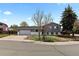 Charming residence boasts a well-maintained lawn, mature trees, and a convenient two-car garage for added curb appeal at 690 S Newark Ct, Aurora, CO 80012