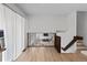 Bright open hallway with hardwood floors and wooden railing leading to the stairs at 690 S Newark Ct, Aurora, CO 80012