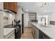 Bright and airy kitchen featuring a chef's range, ample counter space and bar-style seating at 690 S Newark Ct, Aurora, CO 80012