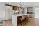 Modern kitchen featuring a large island with seating, custom wood accents, and stainless steel appliances at 690 S Newark Ct, Aurora, CO 80012