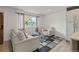 Cozy living room featuring natural light, stylish decor, and comfortable seating at 690 S Newark Ct, Aurora, CO 80012
