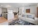 Bright open concept living and kitchen area with hardwood floors and recessed lighting at 690 S Newark Ct, Aurora, CO 80012